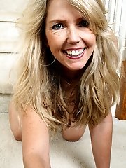 Blonde MILF Ginger B spreads her ass wide for you on the stairs